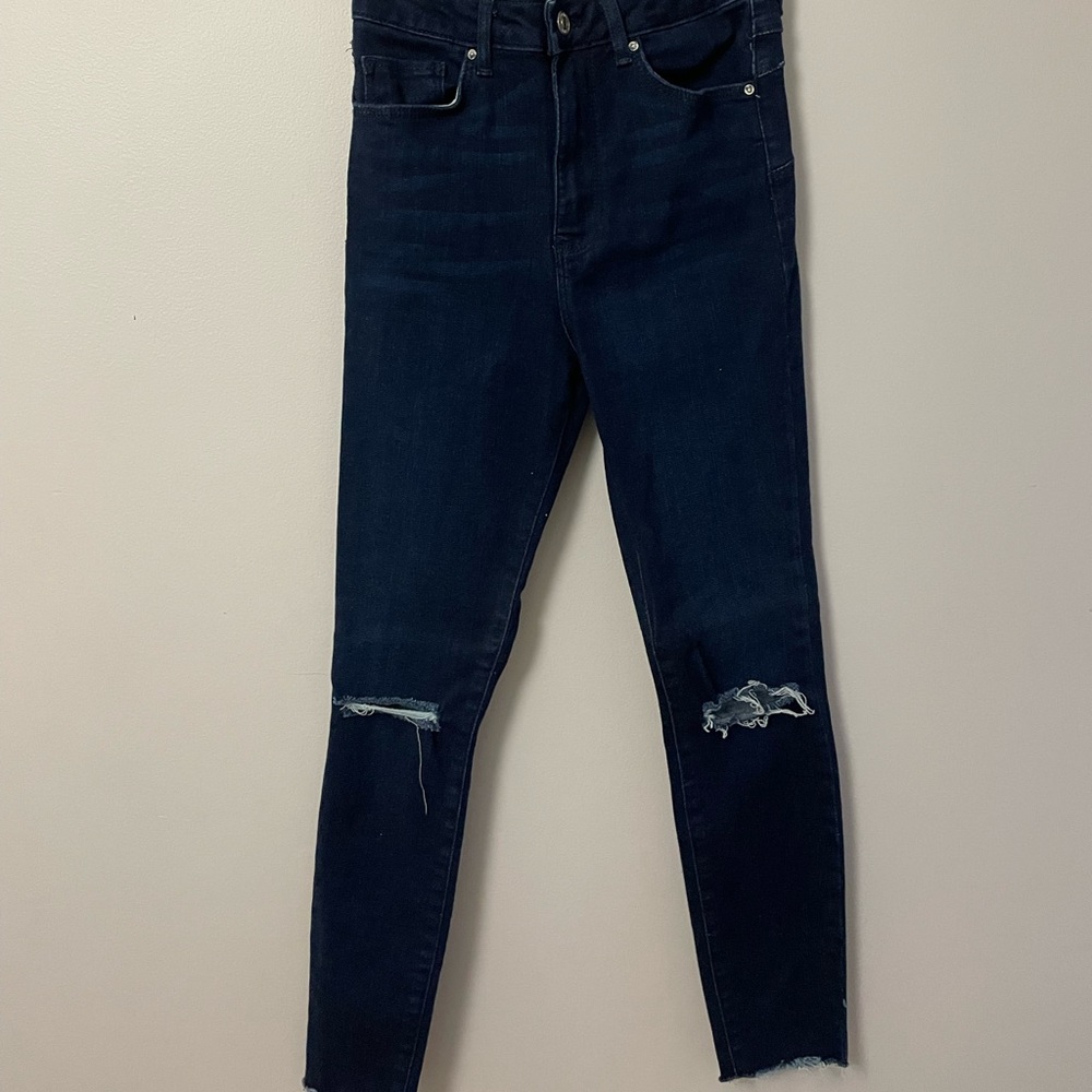 Dark wash ripped-knee skinny jeans